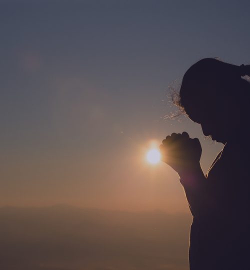 Teenage girl with praying. Peace, hope, dreams concept.